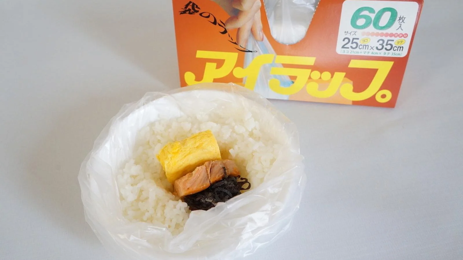 Rolled omelette, salmon and kombu placed in a hollow in the rice